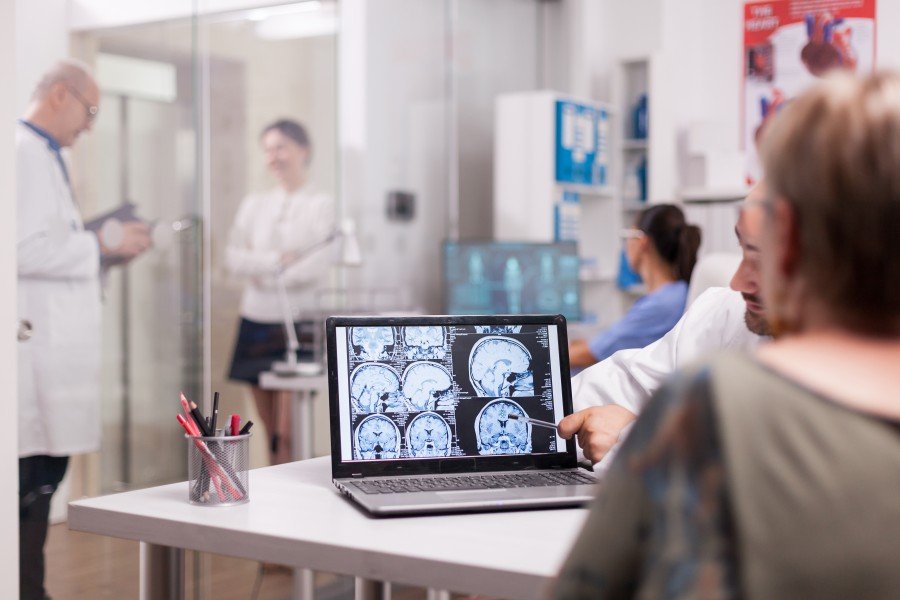 Neurotherapist discussing brain scan results with a patient