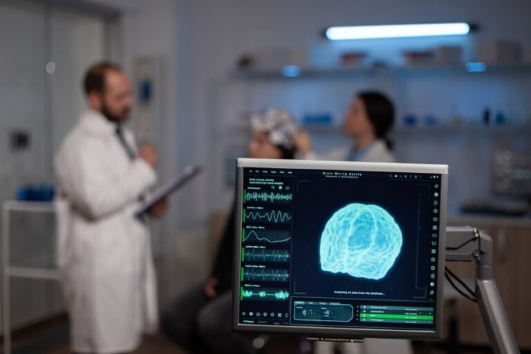 Neurotherapy practitioner assessing a patient using brain monitoring equipment in a clinical setting